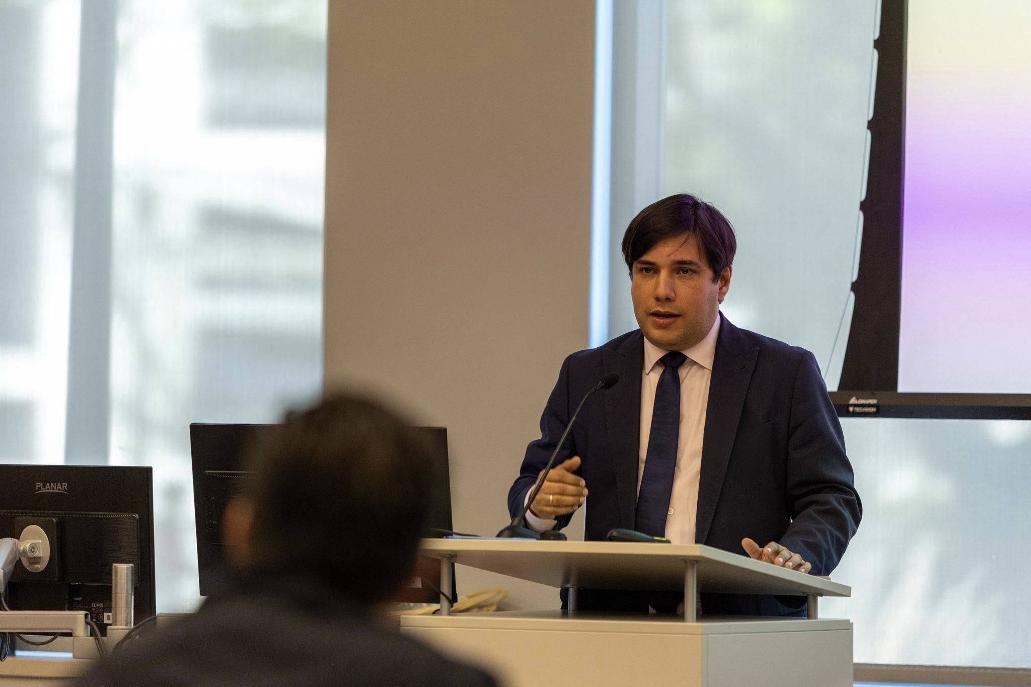 Panel discussion with speaker holding microphone